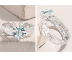 Macro detail of S925 sterling silver hammered band and blue heart zirconia setting