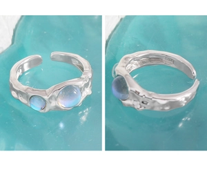 Macro detail of S925 sterling silver ring with moonstone and irregular lava texture