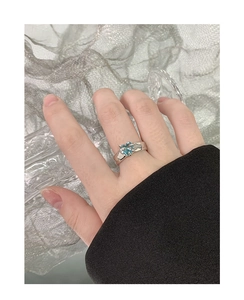 Close-up of S925 silver ring featuring a light blue heart-shaped zircon on a wide band