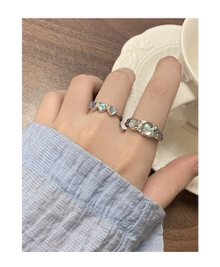 Detail of S925 silver rings with opal heart and irregular moonstone texture design