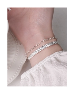 Macro shot of S925 sterling silver chain bracelet with vintage textured open bangle set