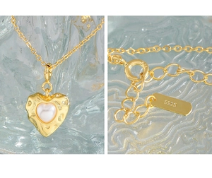 Macro view of S925 sterling silver stamp and heart pendant with pearl texture