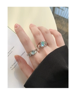 Detailed view of liquid metal style S925 silver moonstone rings with textured lava design