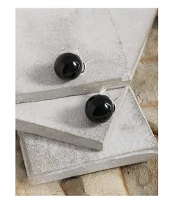 Macro shot of minimalist black onyx bead earrings with S925 sterling silver hooks