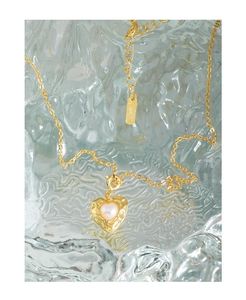 Detailed macro view of S925 sterling silver stamp on a gold heart pearl pendant