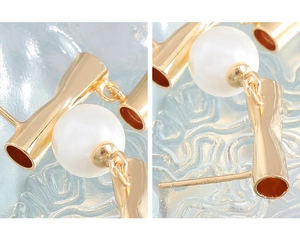 Macro view of asymmetrical gold-plated S925 silver earrings with pearls and geometric metal