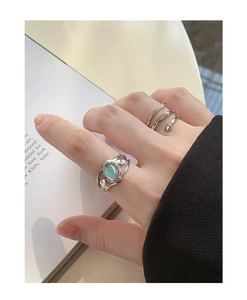 Close-up of S925 silver moonstone ring with textured finish and lava design on a hand