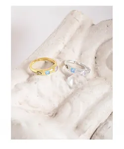 Detail of adjustable rings with colorful zircon stones and hammered texture on stone base