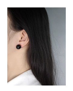Minimalist black onyx ball earrings on model showing size ratio and glossy finish