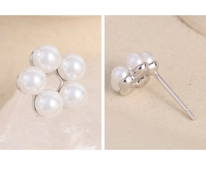 Close-up of S925 sterling silver hallmark on elegant white pearl flower stud earrings
