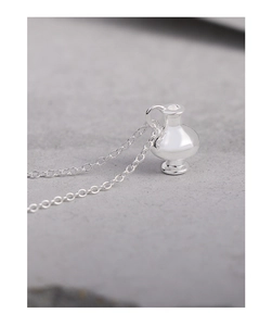 Detailed close-up of a high-polished S925 sterling silver vase pendant on a delicate chain