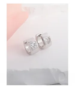 Macro view of heart-shaped zircon inlay and S925 silver hallmark on hoop earring