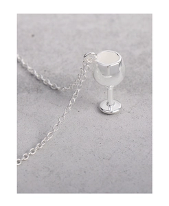 Macro shot of polished S925 sterling silver wine glass pendant on a delicate chain