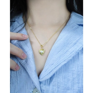 Elegant gold S925 silver necklace with textured heart pearl pendant on a model
