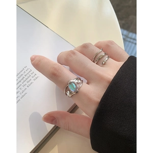 Modern S925 silver ring set with shimmering moonstone and organic lava texture design