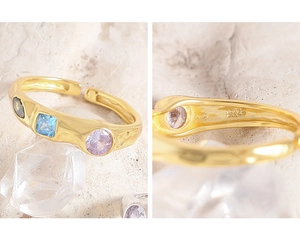 Macro detail of S925 hallmark on gold plated hammered ring with colorful zircon stones