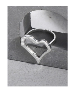 Macro detail of silver S925 heart ring with irregular fold texture on grey stone