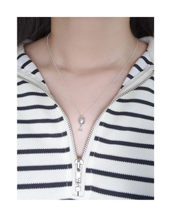 Silver wine glass pendant necklace shown on model wearing black and white striped sweater