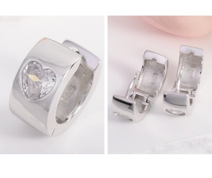 Macro detail of S925 sterling silver hoop earrings with heart-cut zircon stone inlay