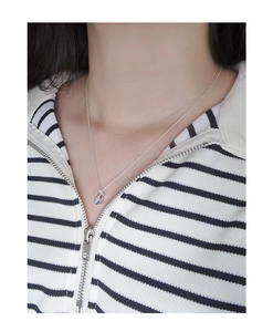 Close-up of minimalist S925 sterling silver necklace with geometric pendant on neck