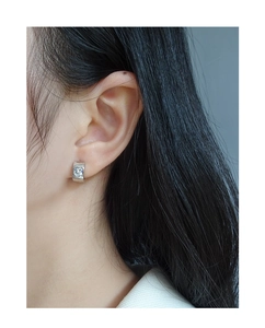 Detail of S925 sterling silver wide hoop earring featuring a sparkling heart zircon stone