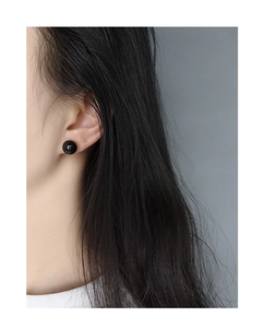 Minimalist S925 sterling silver stud earring with a glossy black agate sphere on a model