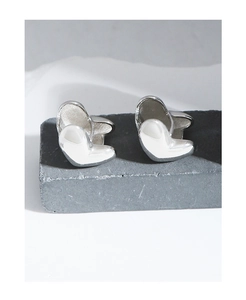 Detailed view of silver heart-shaped earrings with a high-polished mirror finish