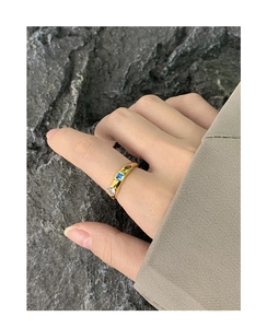 Detailed view of a gold S925 ring with wrinkled texture and colorful zircon stones