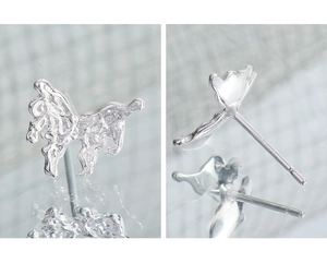 Macro shot of S925 sterling silver butterfly earrings with liquid metal texture detail