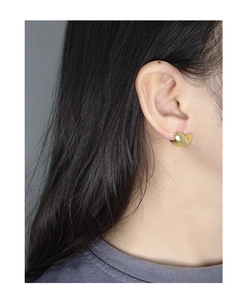 Close-up of minimalist gold heart earring on model featuring polished S925 sterling silver