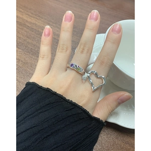 Layered silver rings featuring colorful cubic zirconia and irregular hollow heart design