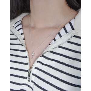 S925 sterling silver wine glass pendant necklace shown on a model wearing striped shirt
