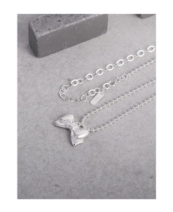 Detail of silver bow pendant on beaded S925 sterling silver chain necklace