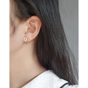 S925 silver wreath pearl stud earrings for women shown worn on a model's ear