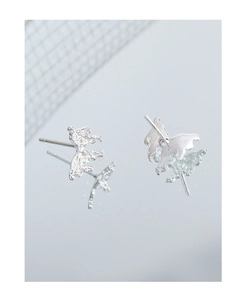 Macro shot of S925 silver butterfly earrings with irregular liquid metal lava texture