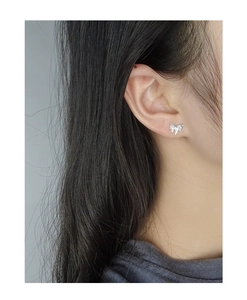 Close-up of S925 sterling silver butterfly stud earring with liquid metal texture on ear