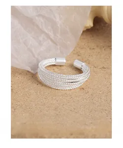 Detail of S925 silver multi-layer wrap ring with delicate beaded texture and open design