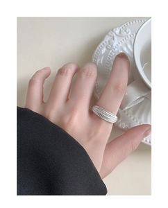 Detail shot of a multi-layer sparkling S925 silver ring with zircons on model hand