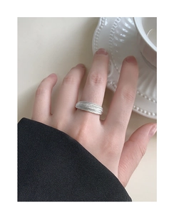 Detailed view of S925 silver layered textured wide ring with woven bead pattern