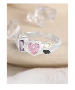 Detailed macro of S925 silver open ring featuring a pink heart zircon and multicolor gems