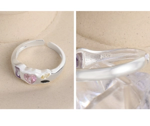 Macro detail of S925 sterling silver stamp and colorful zircon gemstones on open ring