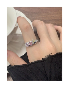 Detail of S925 silver ring with irregular wave design and colorful zircon stones