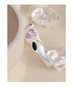 Detail of organic lava style S925 silver ring with pink heart and yellow zircon
