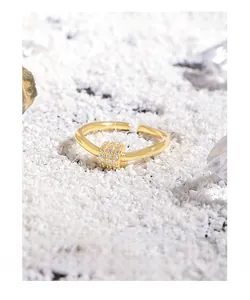 Detailed macro view of 18K gold-plated adjustable ring with a paved zircon spinning bead