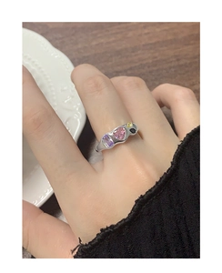 Close-up of S925 silver ring featuring colorful zircon stones in a bypass design