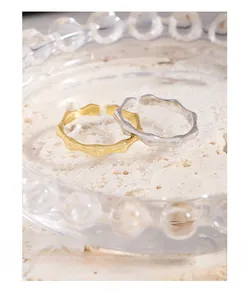 Detailed view of S925 sterling silver bamboo rings in gold and silver on glass tray