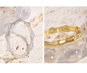 Macro detail of S925 sterling silver bamboo joint rings in silver and gold finishes
