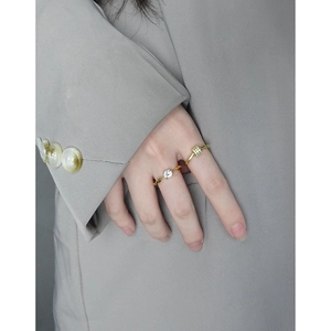 Elegant gold-plated S925 silver rings with zircon stones on a gray suit background