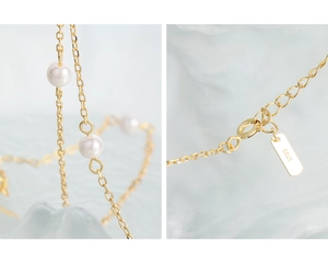 Detailed macro view of S925 sterling silver stamp on the gold pearl necklace clasp