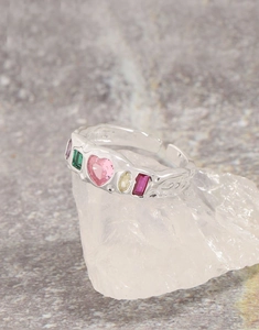 Detail shot of a silver S925 ring with colorful zircons and textured relief band